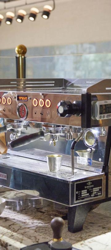 A barista at BPM makes an espresso beverage at the machine