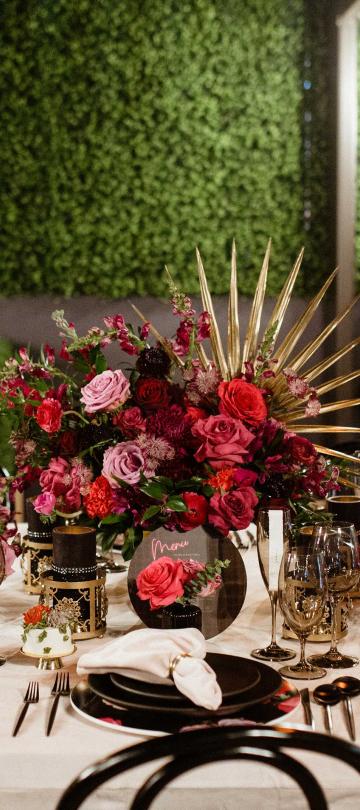 An elegant place setting with large floral centerpieces on a white tablecloth at Viceroy Washington DC
