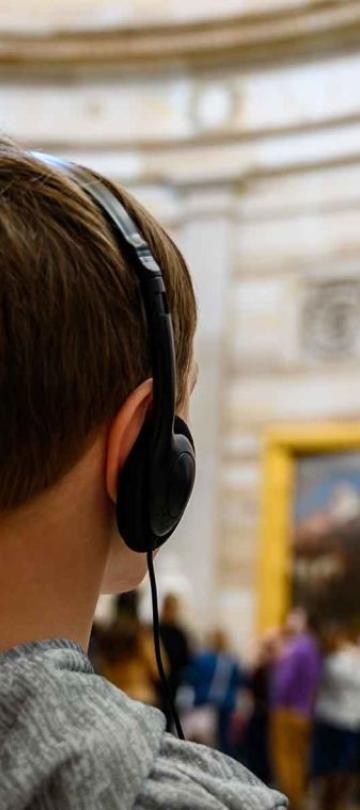 A child listens to a recording on headphones at a Washington museum