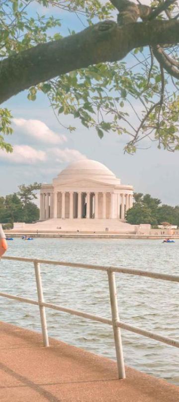 A father and daughter ride scooters along the bank of a Washington river