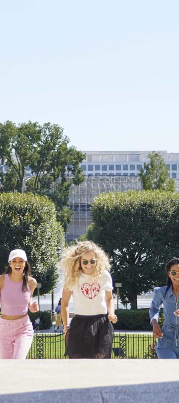 three women walking up a set of stairs at a government building in Washington DC