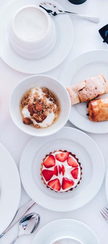 A spread of breakfast food and drinks on a table at Viceroy Zena Washington DC