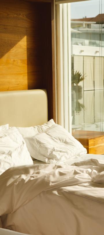 woman stanfing outside beach front villa room