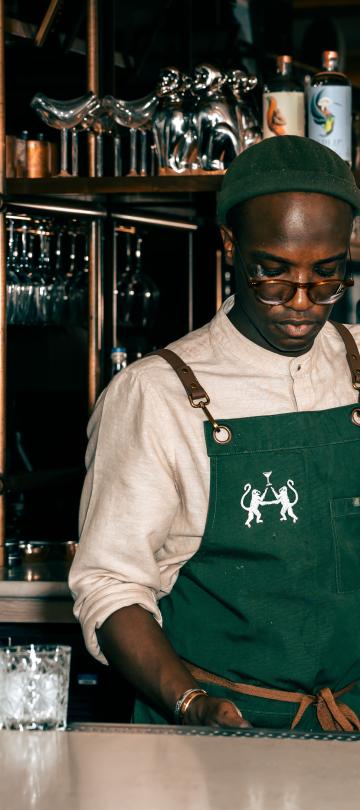 A bartender at Pandan shakes a cocktail