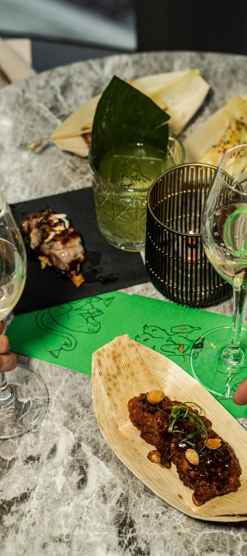 A table with wine glasses and small plates at Pandan