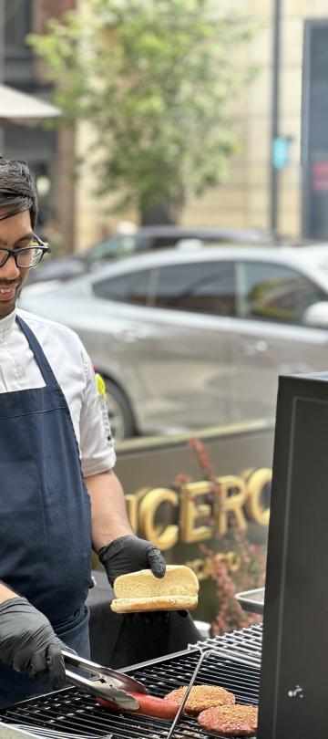 A man grilling on the Somerset patio for the July 4 BBQ, at Viceroy Chicago