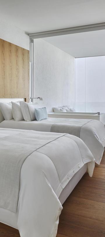 Two double beds in a Viceroy Los Cabos room