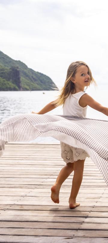 Two children running on a dock in Saint Lucia