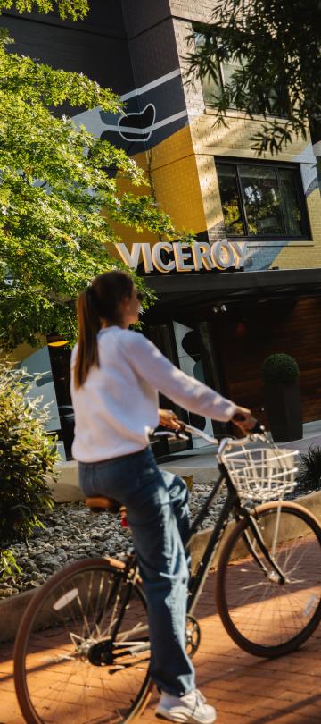 A cyclist rides their bike along a path outside Viceroy Washington DC