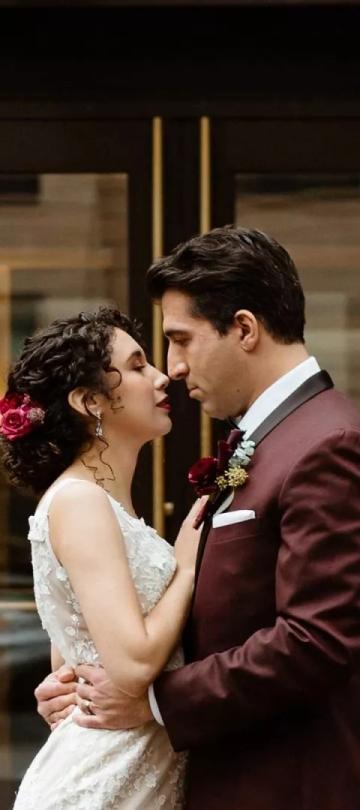 A bride and groom kiss in front of Viceroy Washington DC