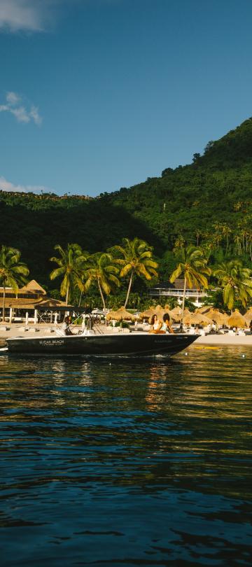 motorboat in ocean in front of beach