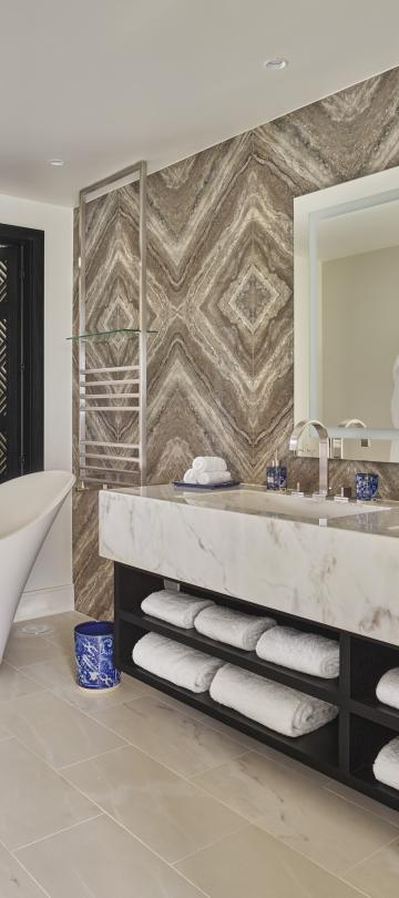 bathroom with double sink and soaker tub