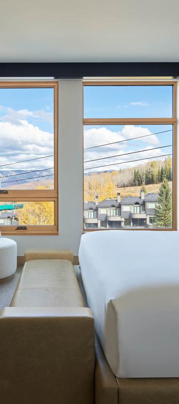 interior of bedroom with tv and exterior views