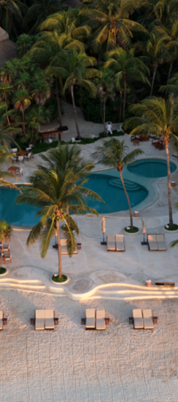 An aerial view of the beach and pool that surround the Viceroy Riviera Maya.