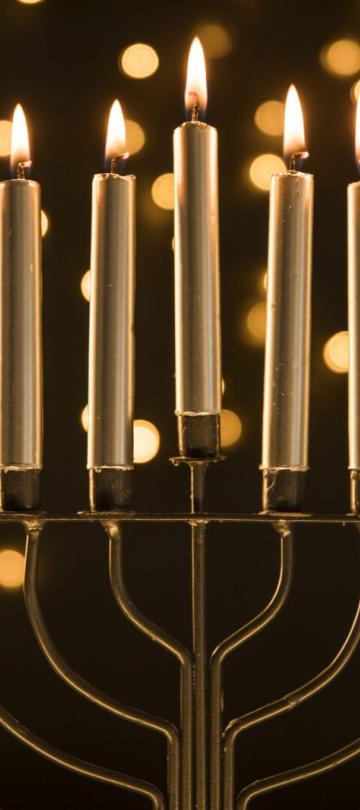 Menorah with lights in the background