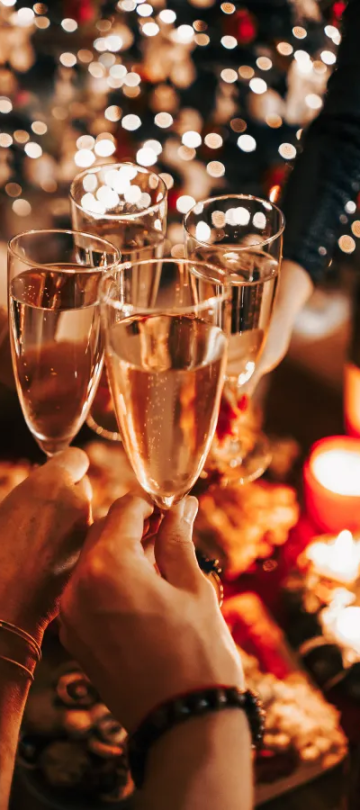Glasses clinking above a festive table setting