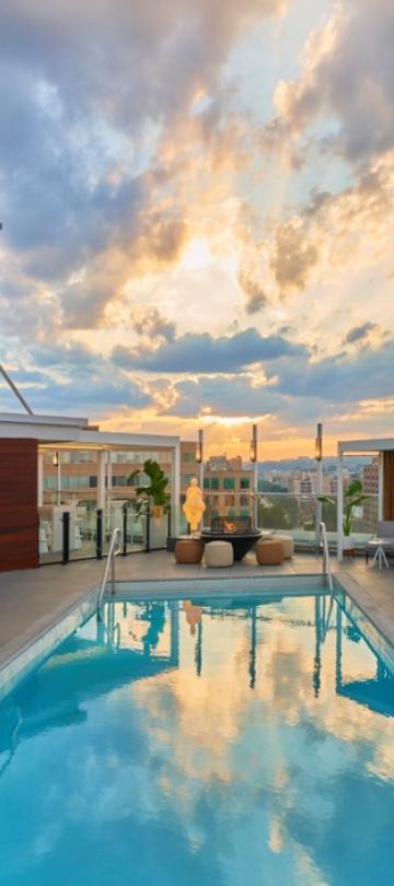 image of Hedy's rooftop at hotel Zena with the sun peeping between clouds
