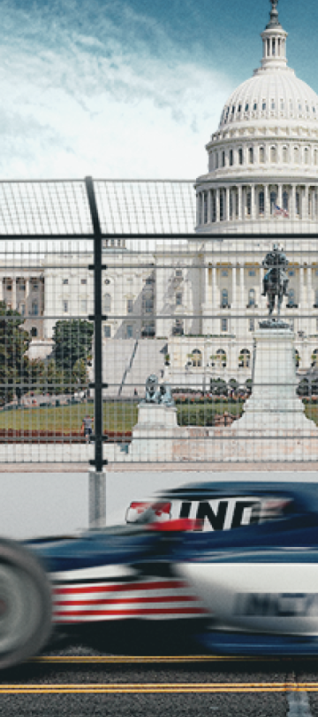 um carro de corrida da Indy a passar pelo Capitólio dos EUA