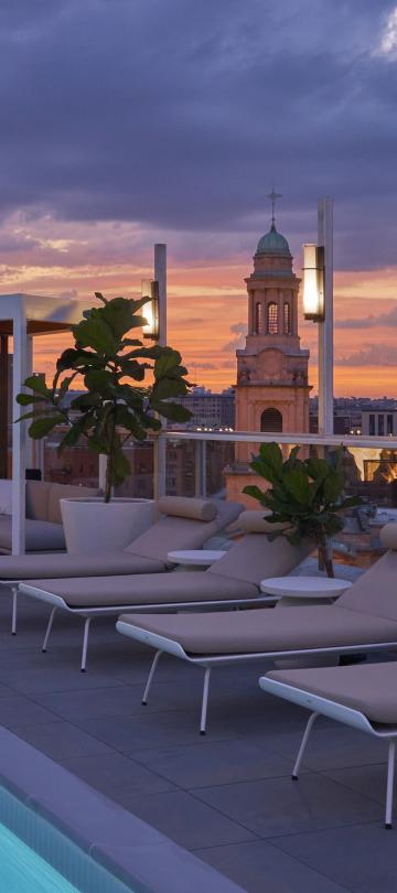 Hedy's rooftop at Hotel Zena at dusk with pink and purple sky
