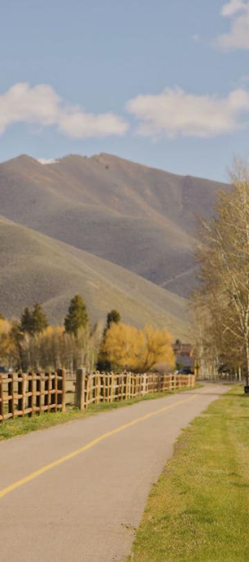 woman riding bike through sun valley