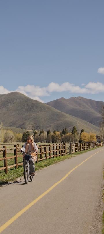 A woman riding a bike through the Sun Valley 