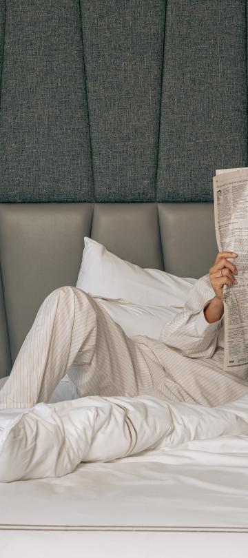 Guestroom with guest reading the newspaper