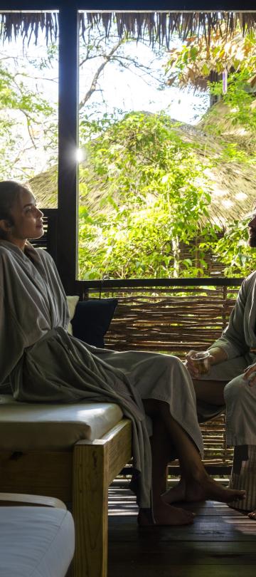 A couple in bath robes relaxing at the Rainforest Spa