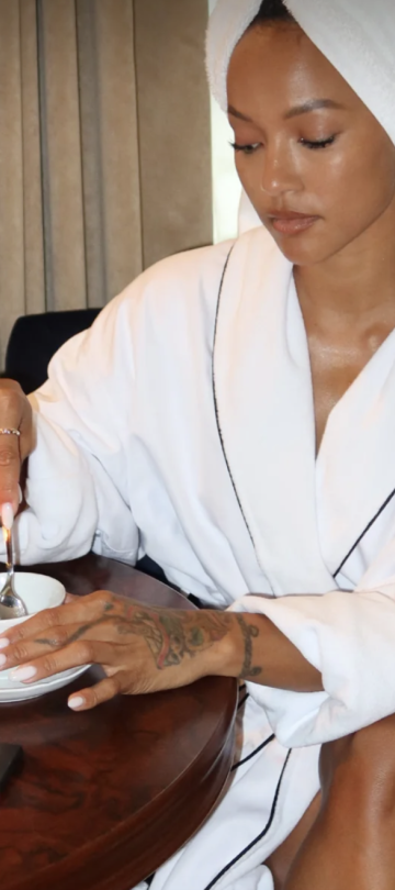 woman in towel drinking tea