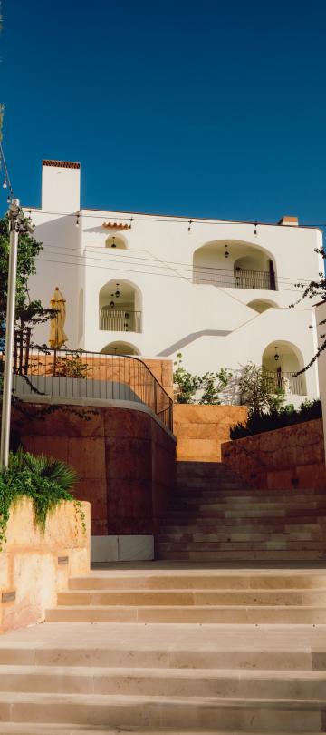 A gleaming white villa at the top of a flight of stone stairs in Ombria Algarve