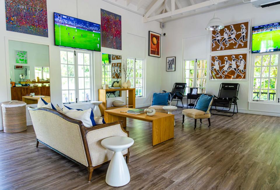 windowed room with TV and comfy furniture