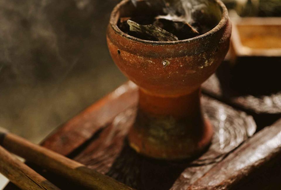 A smoking herb in a vessel at a spa experience