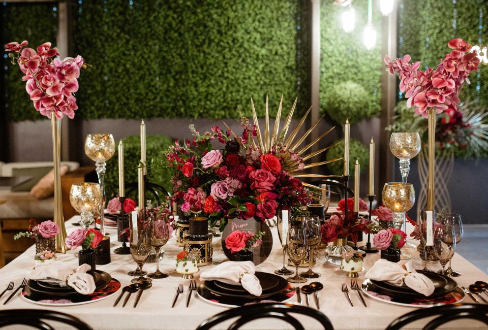 An elegant place setting with large floral centerpieces on a white tablecloth at Viceroy Washington DC