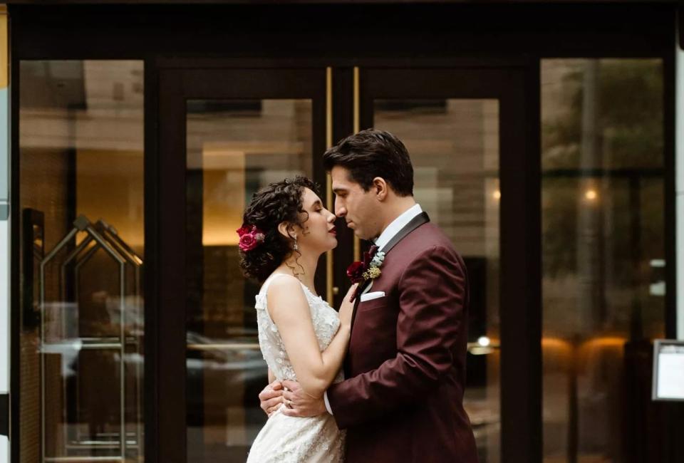 A bride and groom kiss in front of Viceroy Washington DC