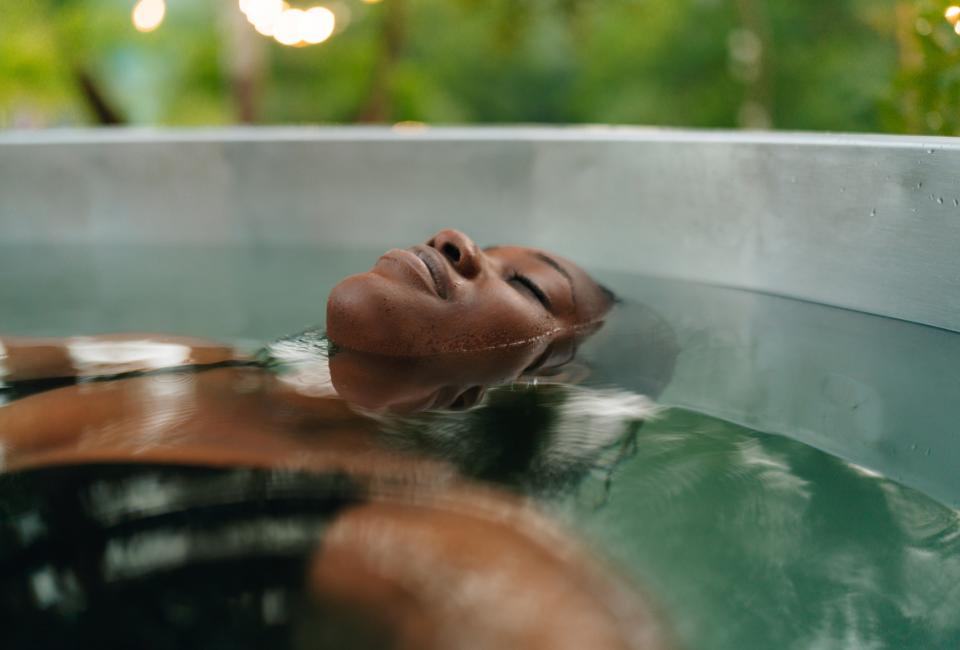 woman floats in cold plunge pool