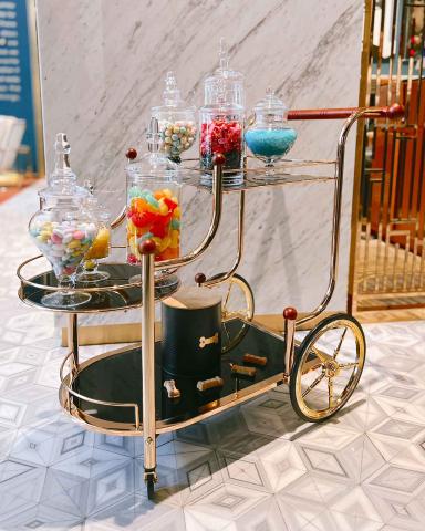 A cart with jars of candy on it