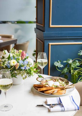 Table of food with flowers and wine
