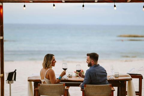 A couple enjoying dinner on the beach