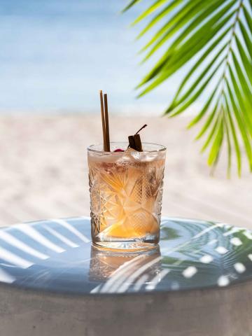 Cocktail sitting on a bench on the beach