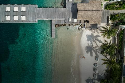 An aerial view of a dock and beach.