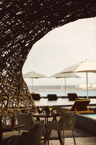 A table with 2 glasses of white wine on a patio at Los Cabos