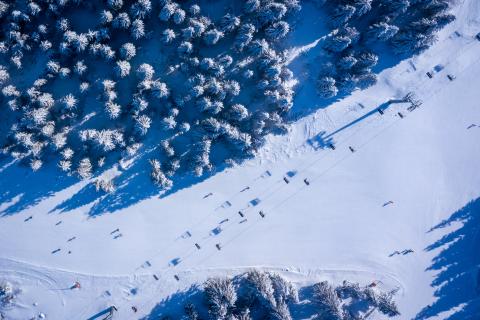 aerial view of chairlift on snow covered mountain
