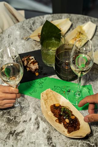 A table with wine glasses and small plates at Pandan