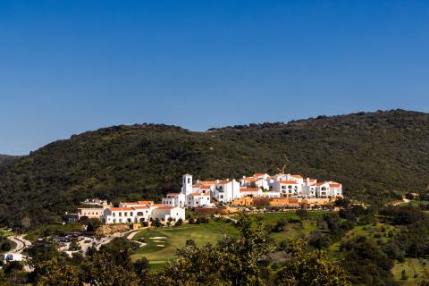 Viceroy Ombria Algarve, a gleaming white resort in the valley of a large, lush green hill