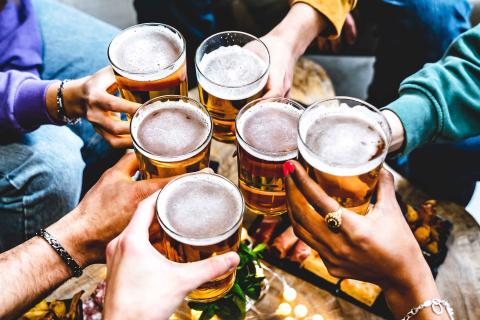 6 peopel cheers-ing beers at Riviera Maya