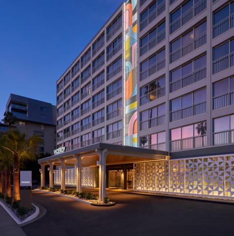 The exterior facade of Viceroy Santa Monica, with a large mural of kaleidoscopic colors ascending the building