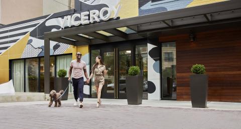 A couple walking a dog outside of Viceroy Washington DC
