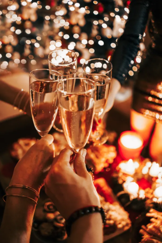 Glasses clinking above a festive table setting