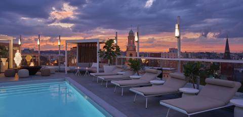 Hedy's rooftop at Hotel Zena at dusk with pink and purple sky
