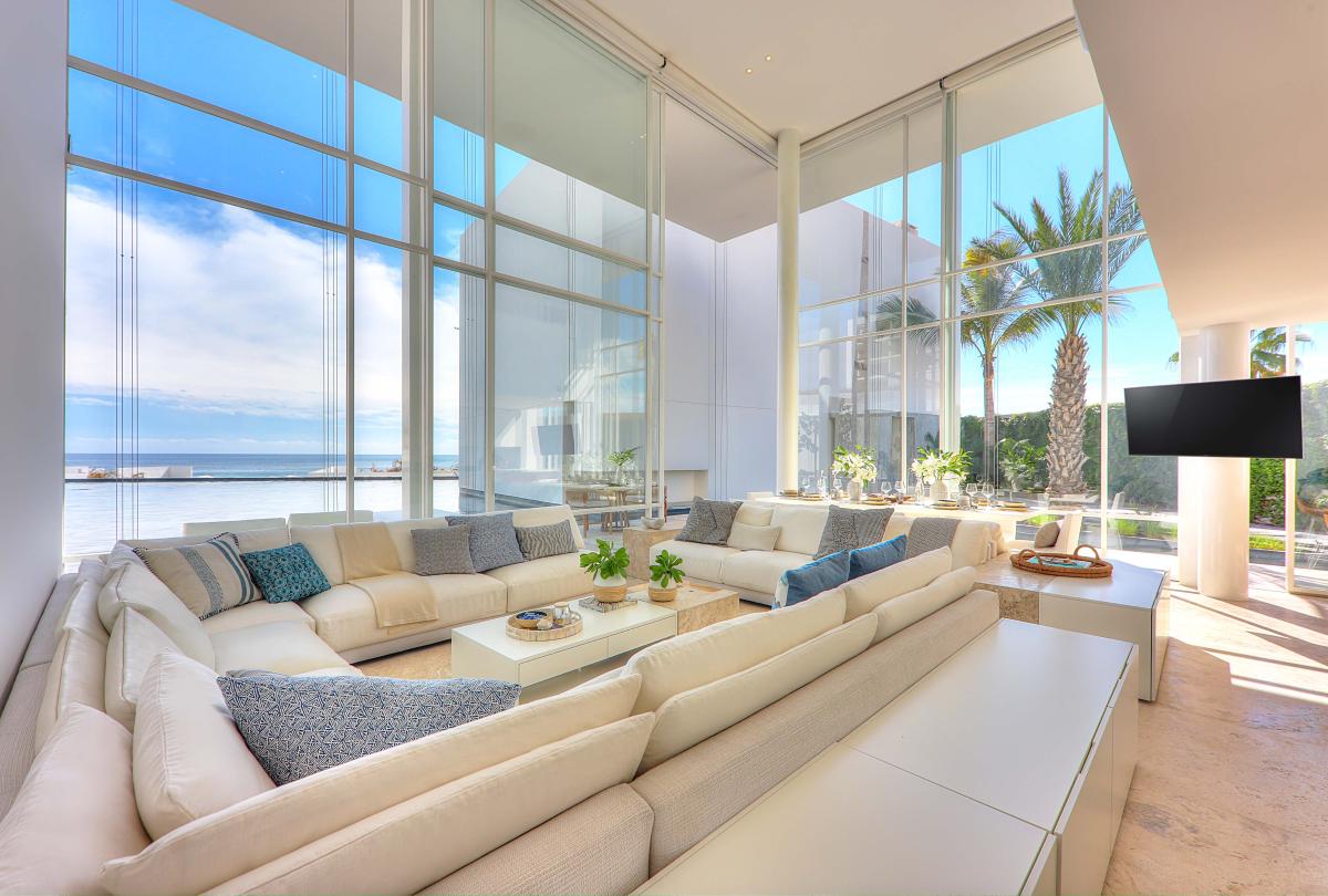 los cabos waterside villa living room area with a large sofa and floor to ceiling windows
