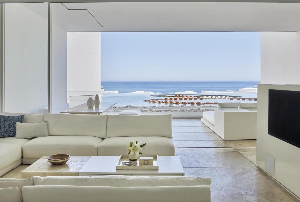 living room area with views of balcony in Los Cabos suite